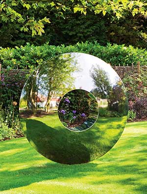 Torus reflecting its surroundings in a classic English garden