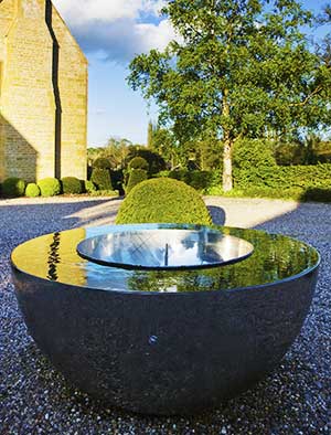 Chalice water feature set on a gravel terrace