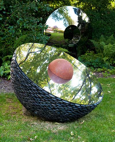 Hemisphere garden sculpture in a garden setting
