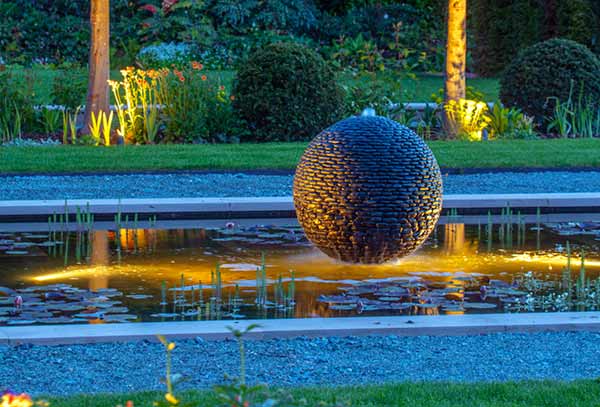 Dark Planet water sphere garden sculpture