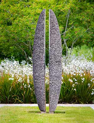 Slate and stainless steel sculpture made from two elegantly poised halves in a state of implausible balance