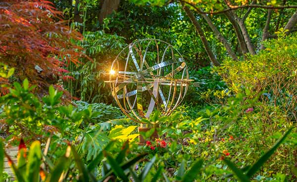 Armillary sundial in woodland style garden in Sydney