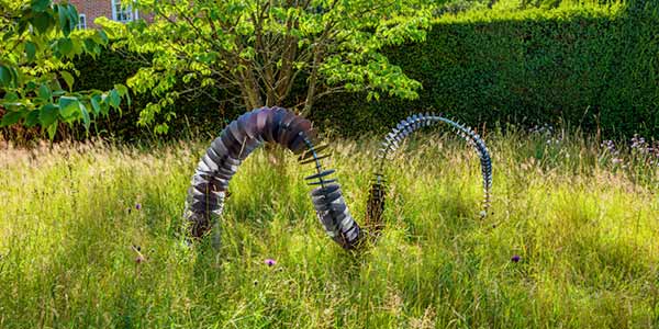 Coluna metal garden art in grass