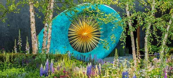 Massive Aeon sculpture in its setting in the Chelsea Show Garden