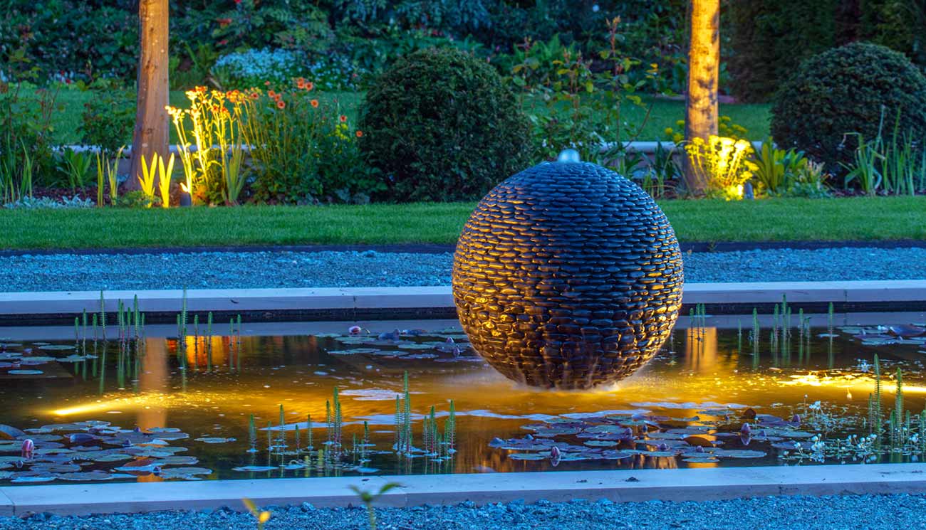 Dark Planet water sphere garden sculpture