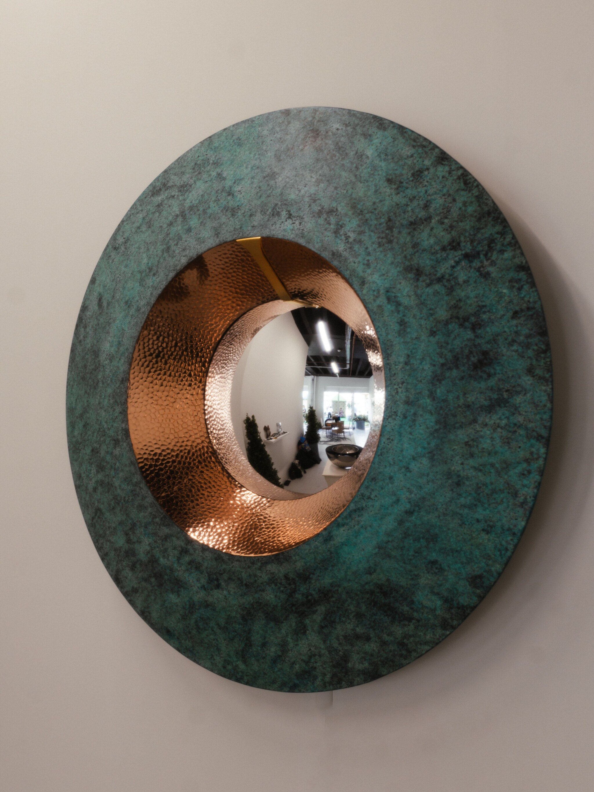 Decorative mirror handcrafted from hammered copper and verdigris bronze.