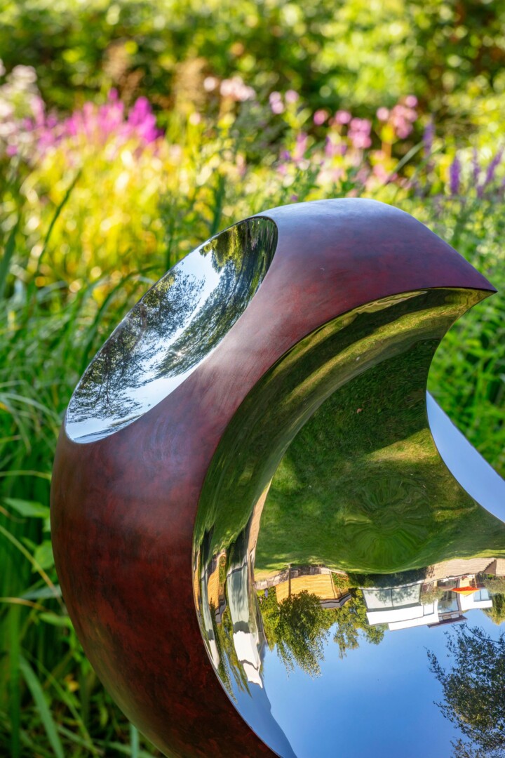 Close up of crimson patina on sphere garden sculpture