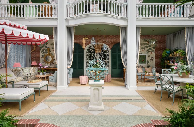 Elegant outdoor patio with columns, seating, plants, and courtyard garden ideas centered around a decorative sphere.