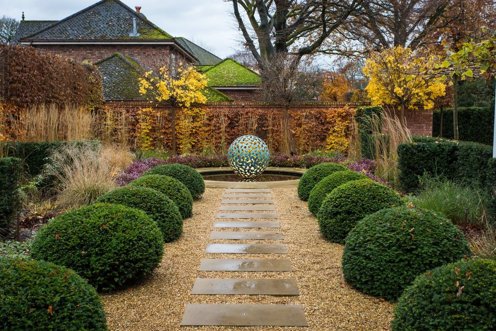 formal, symmetrical garden layout utilizing a central stone or gravel path