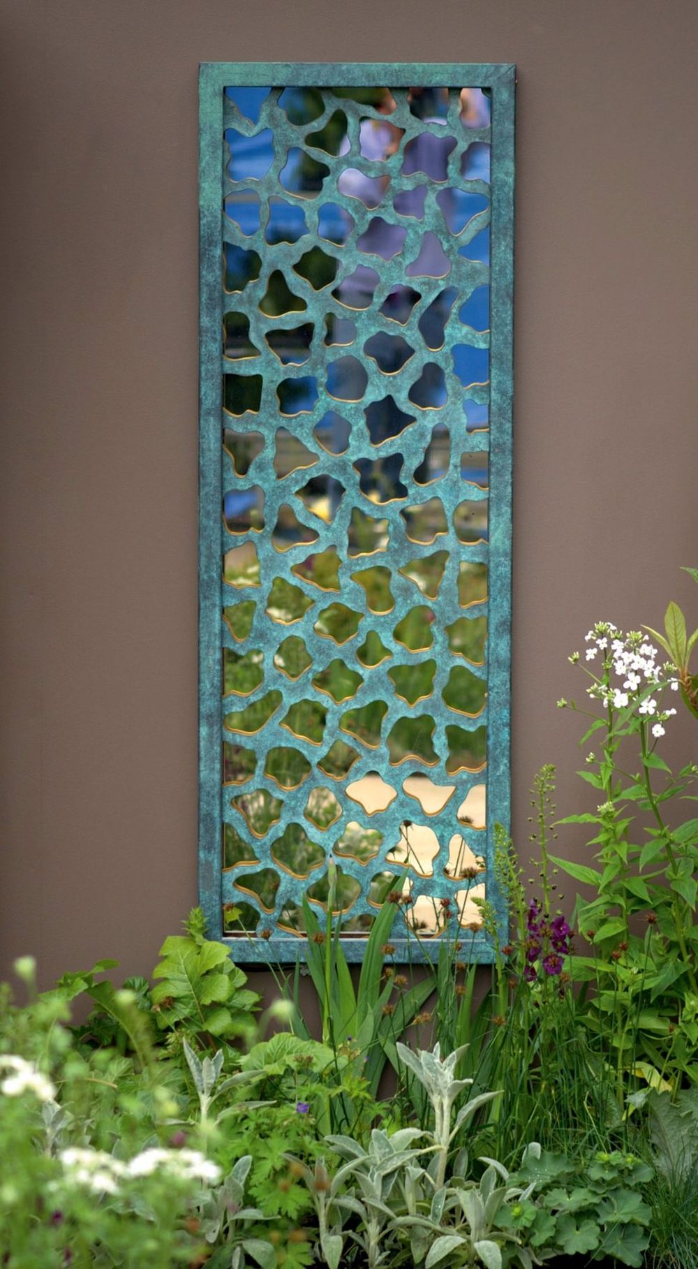 intricate, perforated lattice overlay in a soft blue-green finish