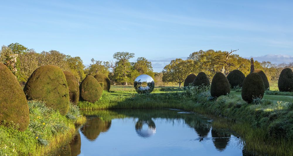 Torus landscape sculpture in slate and stainless steel