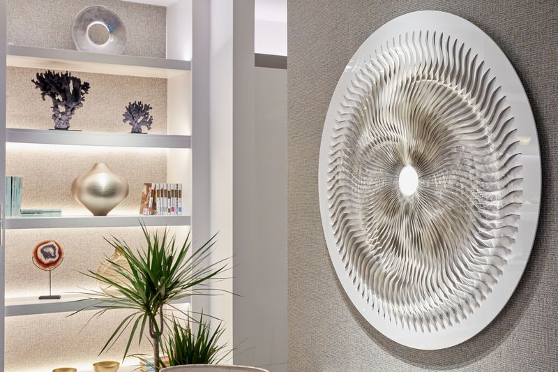 Modern living space with a large circular metallic wall art, perfect for hallway sculpture ideas and stylish décor.
